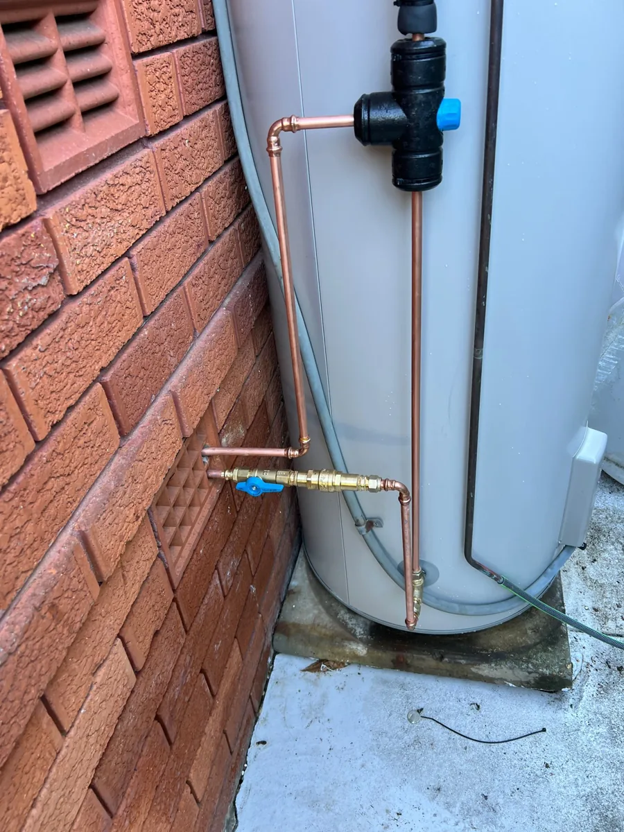 Hot water pipework and valves at the Northmead property